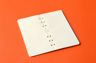 Folded narrow To Do List refill memo pad, orange background, grid pages with ring holes