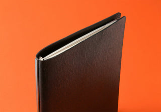 A5 ruler pad booklet with dark cover and rounded spine edge