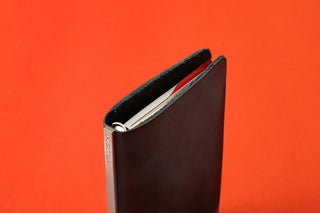 Black ruler pad binder cover with open pocket holding a printed mini protractor