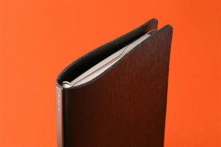 Mini ruler pad notebook with dark cover and clear ruler insert visible