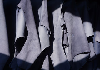 Blue-gray leather panels with textured finish, cut-edge detail