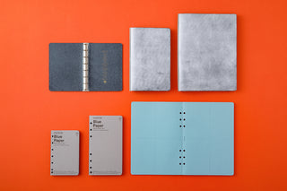 Blue-gray 6-ring leather binder mini size, with rings visible on open cover