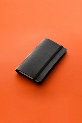 Narrow black band with lifter, folded fabric cover with strap loop