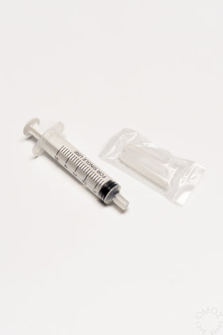 White cleaning syringe tool with nozzle and clear cartridge storage pouch
