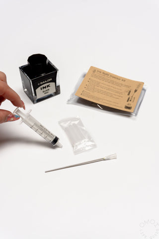 POINT ink cartridge refill kit with hand holding injector syringe and tools
