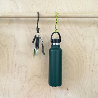 Teal S-hooks with green cord loops and metal carabiners, hanging on wall