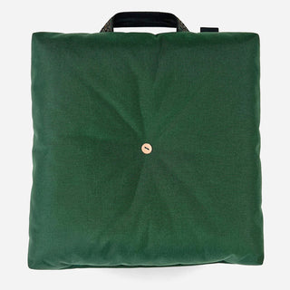 Green outdoor cushion with top carrying handle and central round snap button