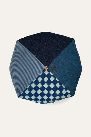 Indigo checkered patchwork cushion with blue striped side panels and tied tassel