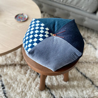 Indigo patchwork cushion with blue checkered top and striped side panels, small tie