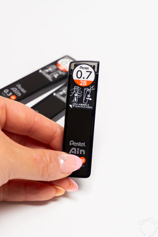 Pentel AIN STEIN 2B lead refill, 0.7mm, held between fingers