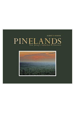 Hardcover book with green cover, PINE LANDS title, landscape photo, and Albert R. Horner