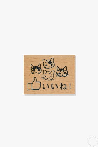 Small wooden stamp with cute cat faces and Japanese thumbs-up text