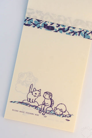 Beige cat memo pad with blue patterned top strip and cats sitting and stretching