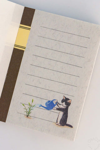 Mini note memo sheet with cat holding blue paint tool and five ruled lines