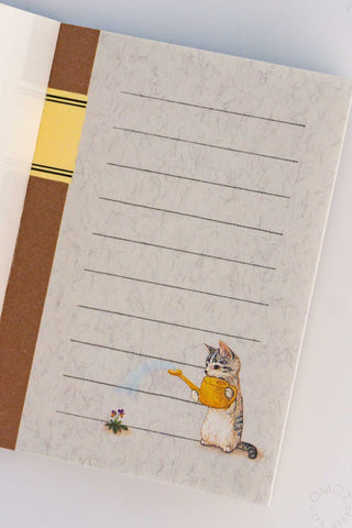 Mini note memo sheet with cat beside yellow watering can and ruled writing lines