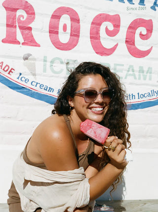 Tortoise-pattern sunglasses on smiling woman, dark lenses
