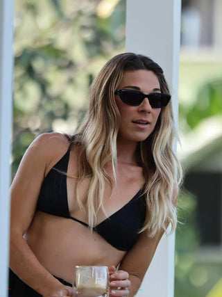 Black polarized sunglasses worn on face, front three-quarter view with dark lenses