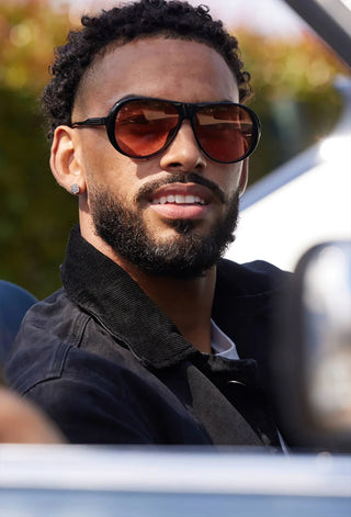 Jenever sunglasses on man, dark frame with warm amber rose tinted lenses