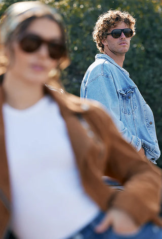 Amber tortoise sunglasses on a man wearing a denim shirt, dark mirrored lenses