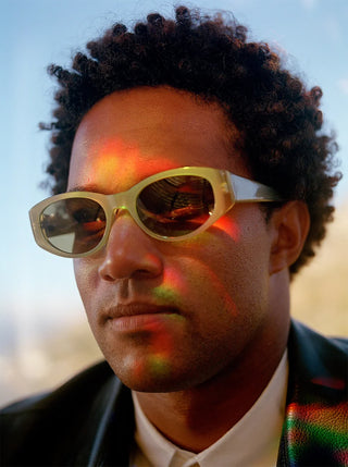 RAEN Kwela sunglasses on face, sage opal frame with brown tinted lenses