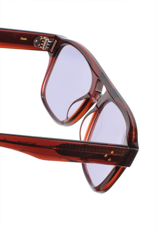 RAEN Rifka Cask sunglasses close-up, tortoise frame with blue tinted lenses