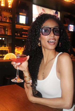 RAEN Rifka Cask sunglasses worn, dark tortoise frame with blue tinted lenses