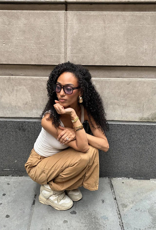 RAEN Rifka Cask sunglasses worn, dark tortoise frame with blue lenses