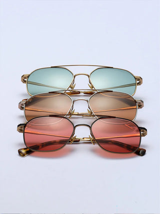 Stacked sunglasses set with multiple colored lenses and gold-and-silver frames.