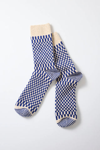 Pair of blue and white checkerboard socks with striped toe and heel
