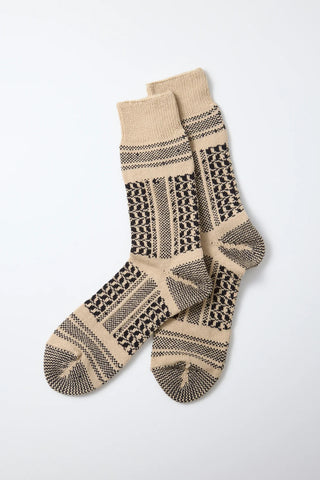 Pair of crew socks with desert-style knit pattern in beige and dark brown with tan striping