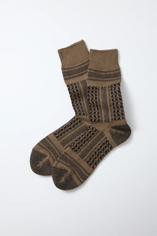 Single pair of crew socks with desert-style knit pattern in dark brown and olive tones