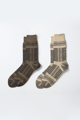 Pair of crew socks with desert-style knit pattern, dark brown and beige with black accents