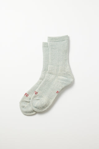Light blue mini crew sock; ribbed knit with small red logo embroidery at the toe.