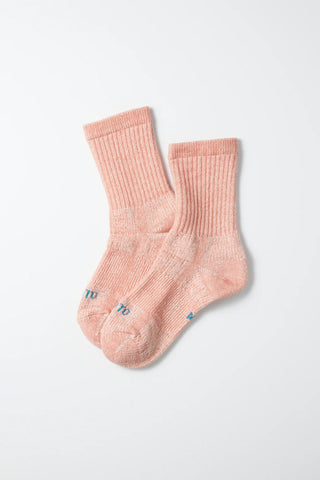 Pair of salmon mini crew socks; ribbed knit with small embroidered logo at the toe.