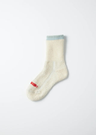 Cream mini crew socks with light blue cuff; small red logo embroidery at the toe.