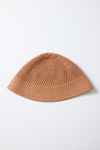 Apricot flax-touch knit beanie hat with ribbed texture, flat lay