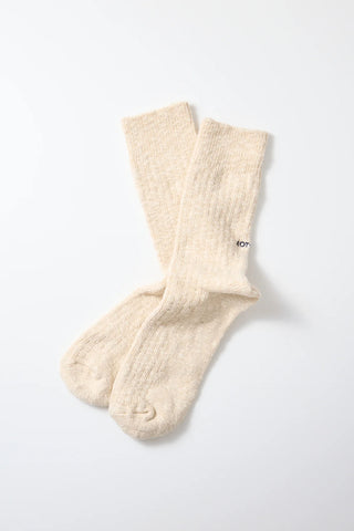 Two ecru slub-knit crew socks stacked with ribbed cuff and cushioned toe/heel
