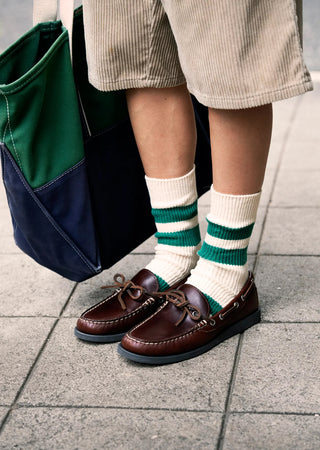 Recycled cotton stripe socks with green stripes on navy background, worn with shoes
