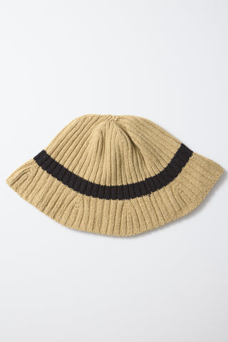 Beige ribbed knit hat with wide black stripe across the brim