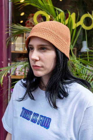 Apricot flax-touch knit beanie hat with ribbed texture, front side view