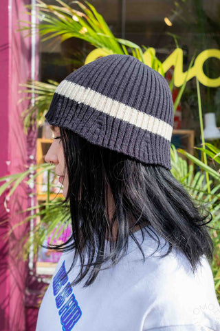 Dark gray knit beanie with wide cream stripe, ribbed cuff