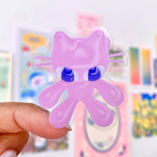 Close-up of pink gummy bunny character sticker with blue eyes on clear backing