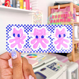 Set of three pink gummy bunny stickers with blue eyes and checker border