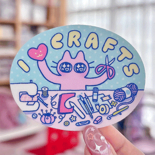 Round blue sticker with colorful cartoon text and doodles, glossy surface