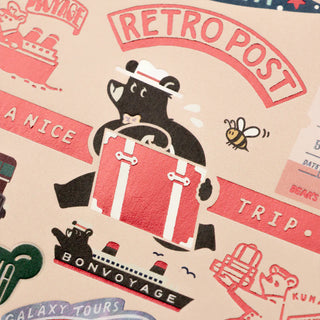 Retro postcard detail with black bear carrying a suitcase and "RETRO POST" badge