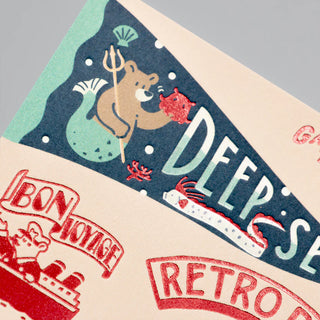 Foil bear travel postcard close-up with "DEEP-SEA" and "RETRO POST" text