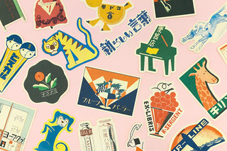 Close-up of assorted fruit parlor retro stickers with grapes, fruit icons, and characters