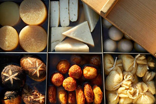 Japanese ingredient tray with round fried items, tofu, and sliced pieces