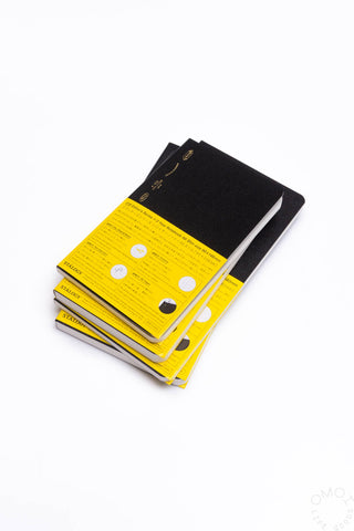 Black slim notebook with yellow label band on the cover