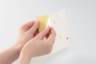 STÁLOGY 024 removable landscape calendar sticker being peeled by hand